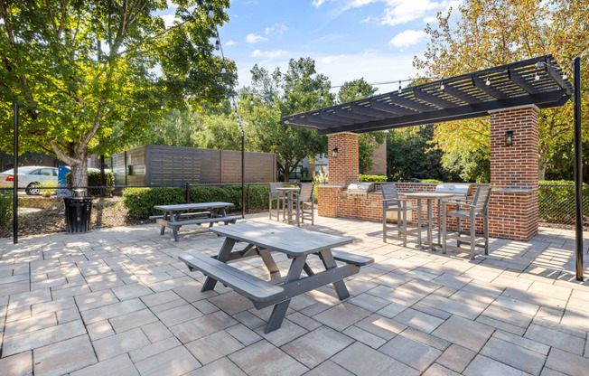 a patio with a picnic table and benches at View at Lake Lynn, Raleigh North Carolina