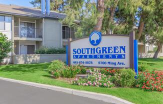 a house that has a sign on the side of a road