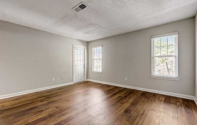 a spacious living room with hardwood floor at Veridian at Sandy Springs apartments