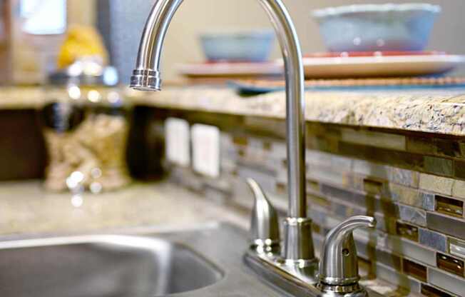 a kitchen sink with a faucet in a kitchen