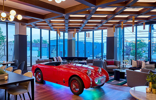 a room with a red convertible car in the middle of it at Dey & Bergen, Harrison, New Jersey