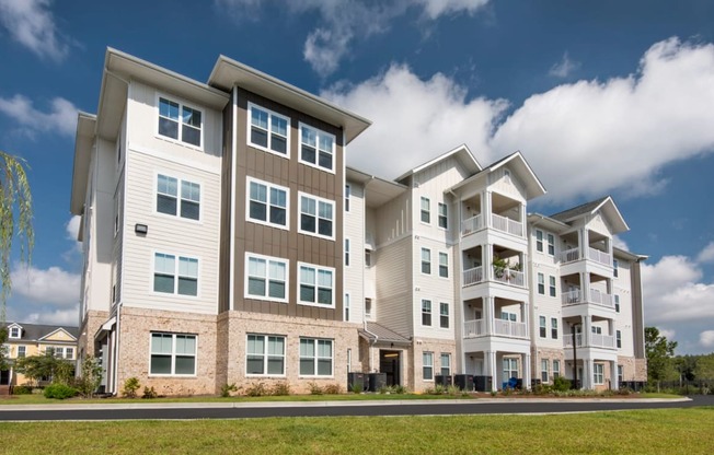 a picture of an apartment complex with a blue sky in the background