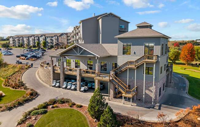 A large, modern building with a parking lot in front.