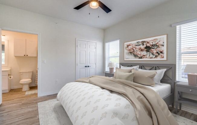 a bedroom with a bed and a ceiling fan