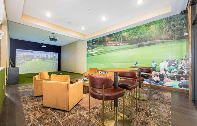 a clubhouse with a large wall mural of a golf course on the wall and chairs
