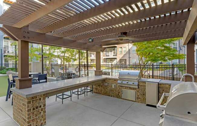A patio with a table and chairs under a pergola at Glenwood at Grant Park, Atlanta, GA