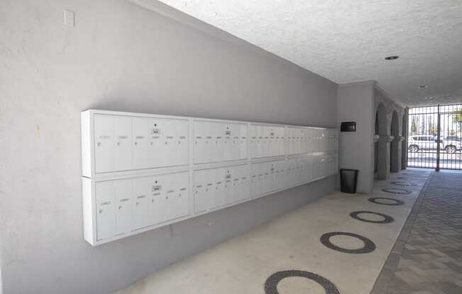 the locker room at the front of the building has a row of white lockers