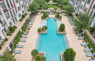 an aerial view of a swimming pool in front of a building