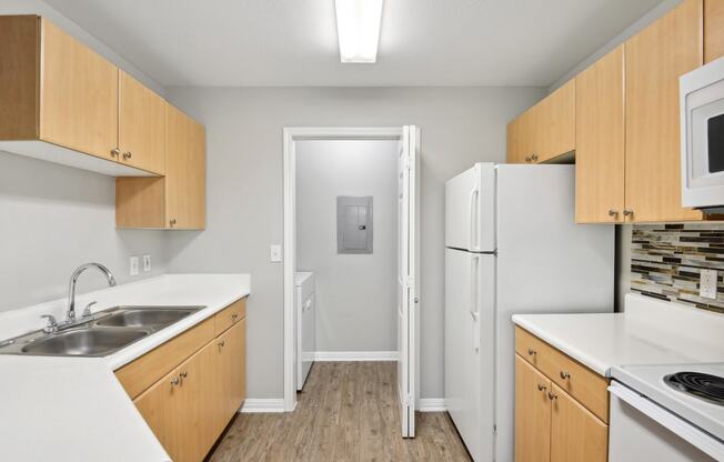 kitchen with white appliances and washer/dryer
