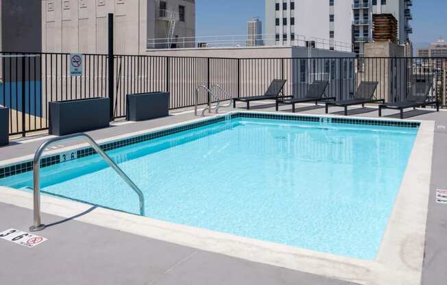 a view of a swimming pool with a city in the background
