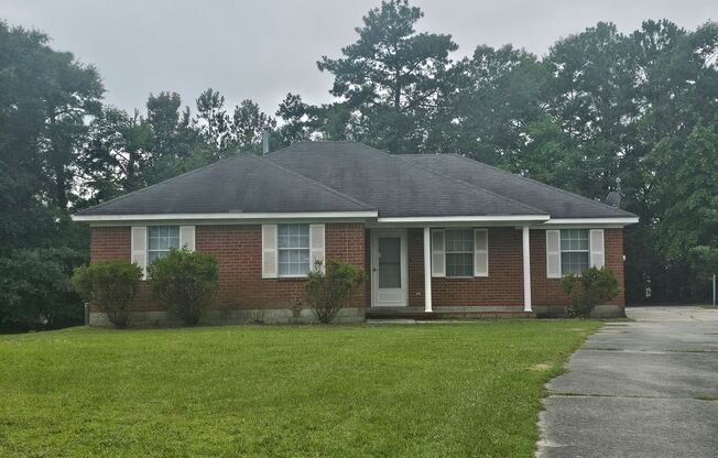 Single family home with covered front porch and back patio.