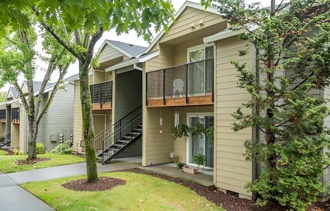 A tree is in front of a house.
