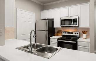 Kitchen with stainless steel appliances and white cabinets