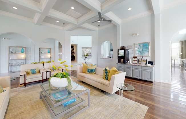 a living room with white walls and a coffered ceiling