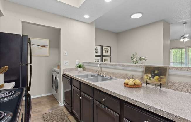 the expansive kitchen with granite countertops and black appliances