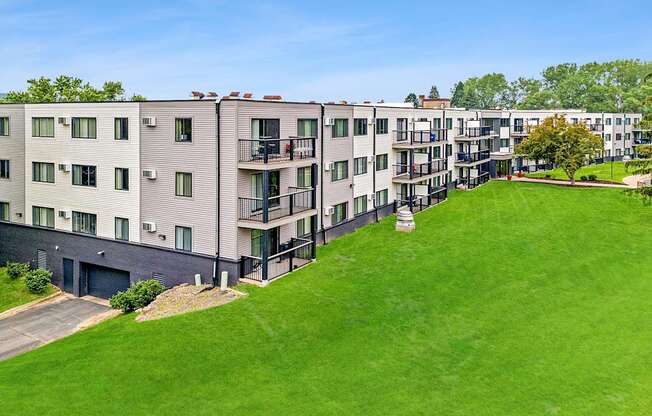 Apartment complex with green grassy area in front.