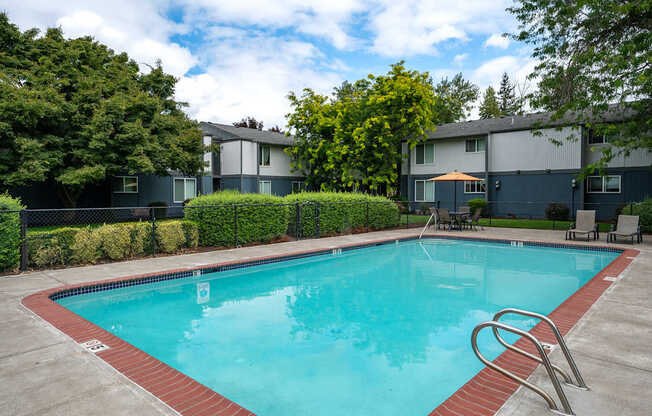 A swimming pool surrounded by a red border and a metal ladder.