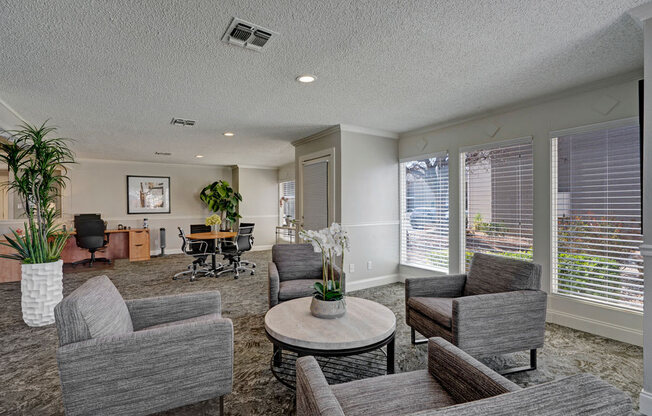 A bright shared workspace at Acacia Park with comfortable seating, large windows for natural light, modern lighting, and flexible areas ideal for working, meeting, or relaxing.