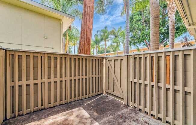 A wooden fence encloses a backyard.