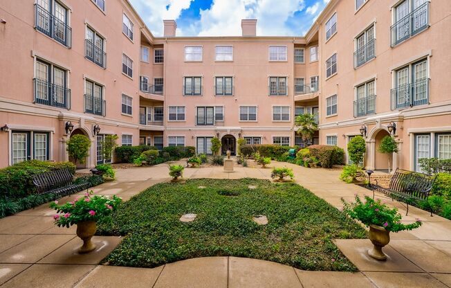 a courtyard with a fountain in the middle of an apartment building