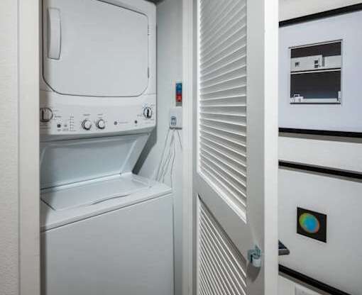 A white oven with a door open is in a kitchen.