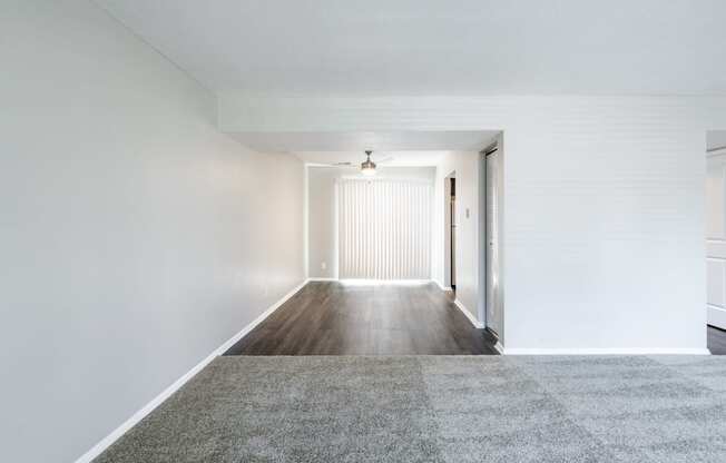 Dining Room with Patio Access and Living Room in the Three Bedroom Townhome at Woodbridge Apartments Bloomington