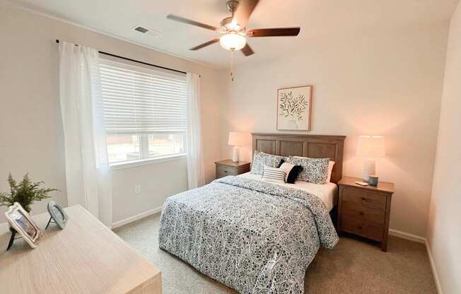 Pet-Friendly Luxury Apartments In Boiling Springs, SC - Grande At Geyser Falls - Carpeted Bedroom Featuring A Large Bed And A Ceiling Fan