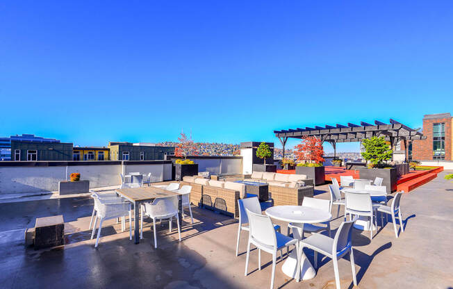 Luxury Apartments for Rent in Seattle - Union Bay - Rooftop with Outdoor Furniture, View of The City, and Planted Trees