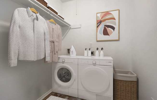 a small laundry room with a washing machine and a counter with a sink and towels