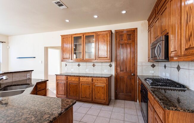 Well kitchen featuring granite countertops, a large island.