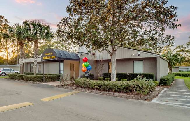 photo of a building with a black awning and balloons in front of it