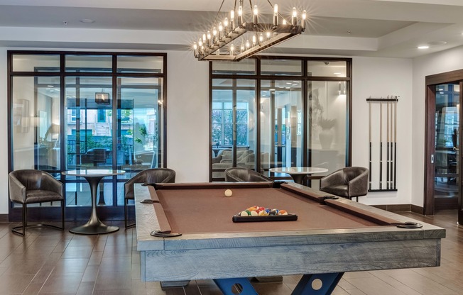 Socialize with friends enjoying a billiards game in the newly redesigned resident lounge