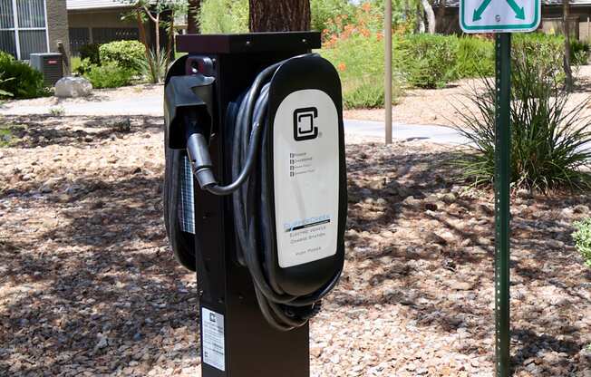 A charging station for electric cars is located in a parking area.