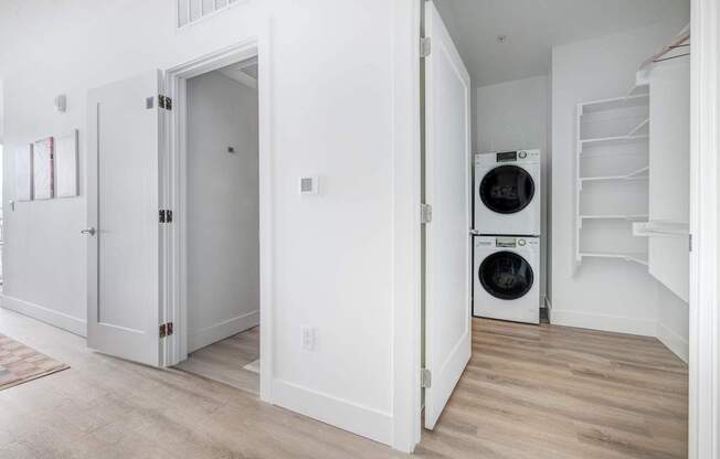 A white laundry room with a washer and dryer.