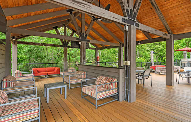 a covered patio with chairs and tables on a porch