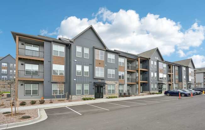 a large apartment building with a parking lot