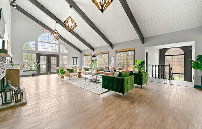 A large, well-lit room with wooden floors and a variety of seating options.