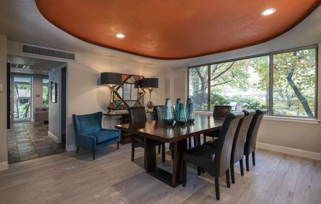 a dining room with a wooden table and blue chairs