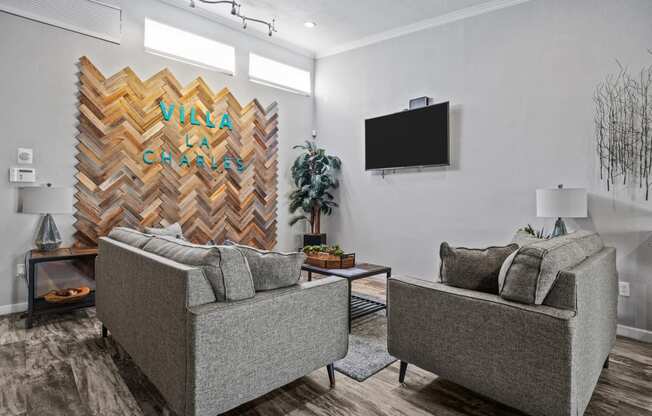 a living room with two couches and a wall mounted tv