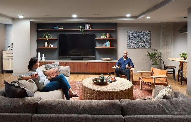 a man and a woman sitting on a couch in a living room