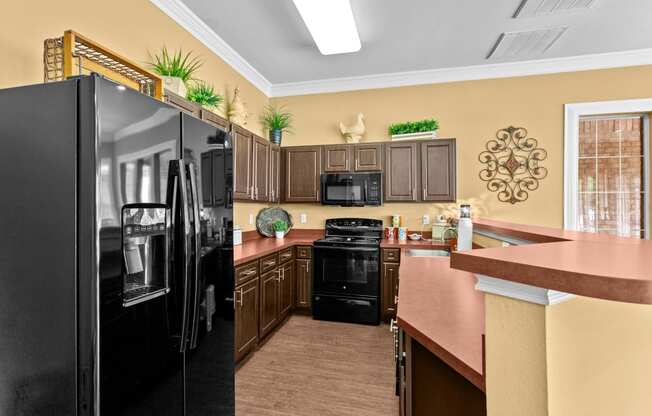 a kitchen with black appliances and a counter top