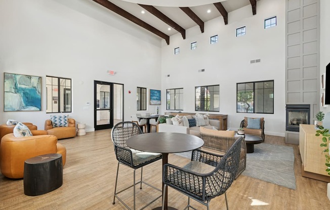 A modern living room with a fireplace and a dining table.