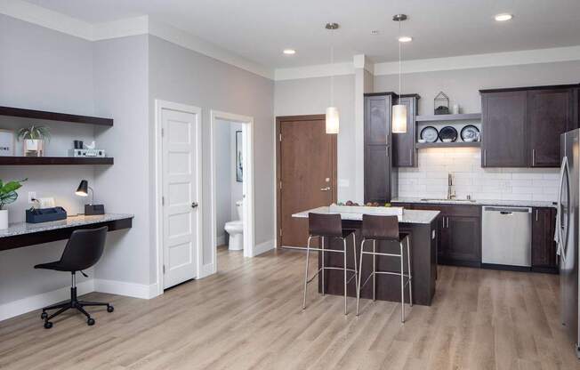 A modern kitchen with dark brown cabinets and a white countertop.