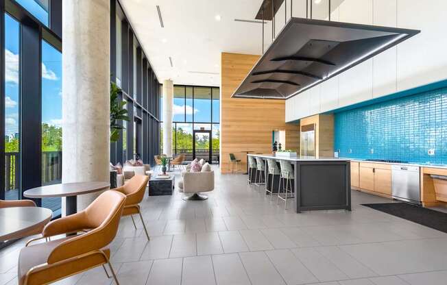 Resident Lounge with Floor-to-Ceiling Windows, Kitchen Area, and Cozy Seating