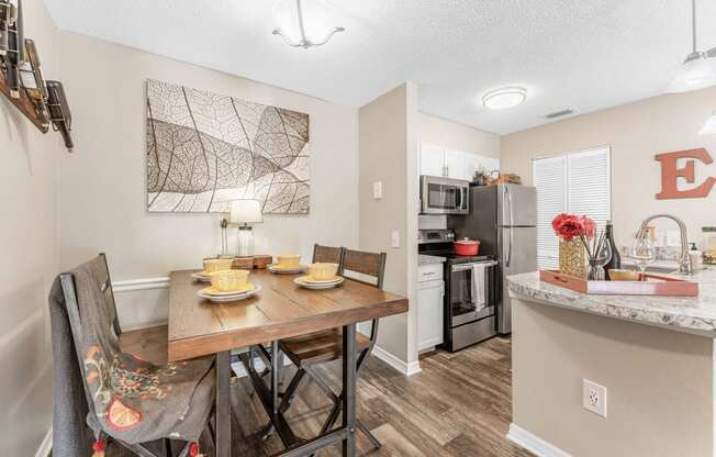 an open kitchen and dining room with a table and chairs