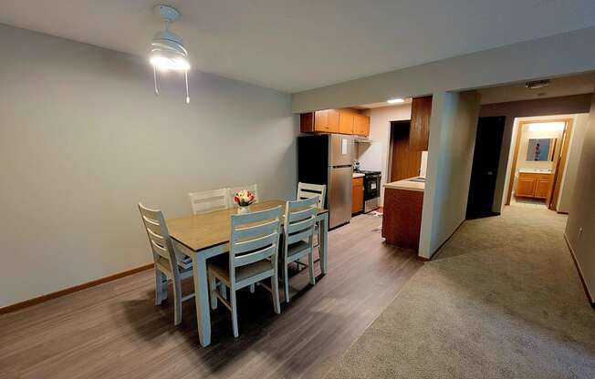 a dining room with a table and chairs and a kitchen