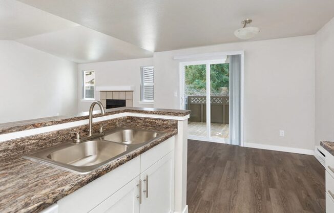 A kitchen with a sink and a counter top.