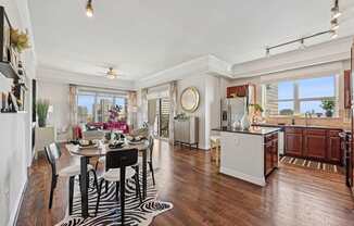 Model kitchen and dining room with a zebra print rug and under the dining table at Dominion Post Oak apartments in Houston, TX