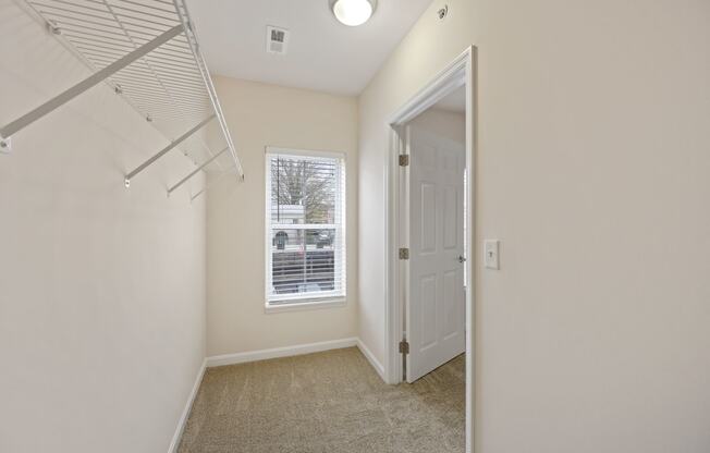 a bedroom with a closet and a window