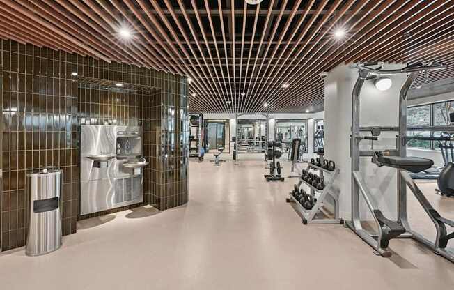 Brand new gym with a variety of equipment and a wooden ceiling.